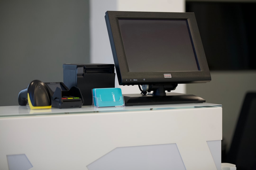 black flat screen computer monitor on white table