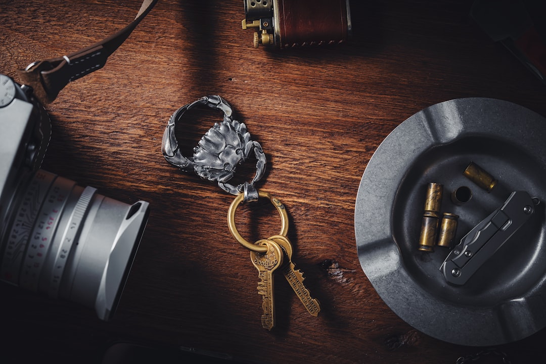 a camera and a pair of keys on a table