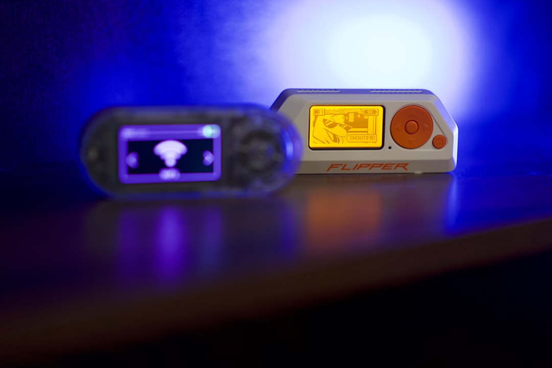 Two portable electronic devices on a reflective surface.