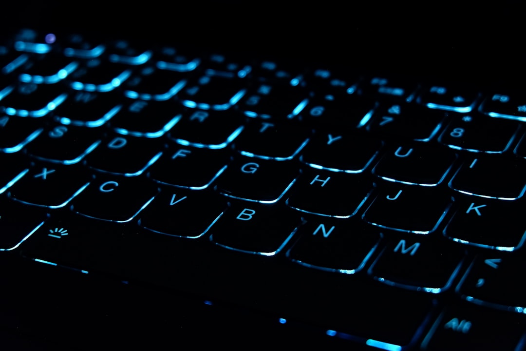 A close up of a computer keyboard on a black background
