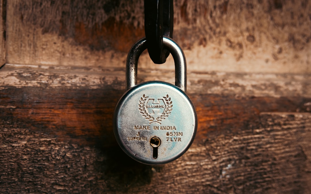 Old padlock securing a wooden door