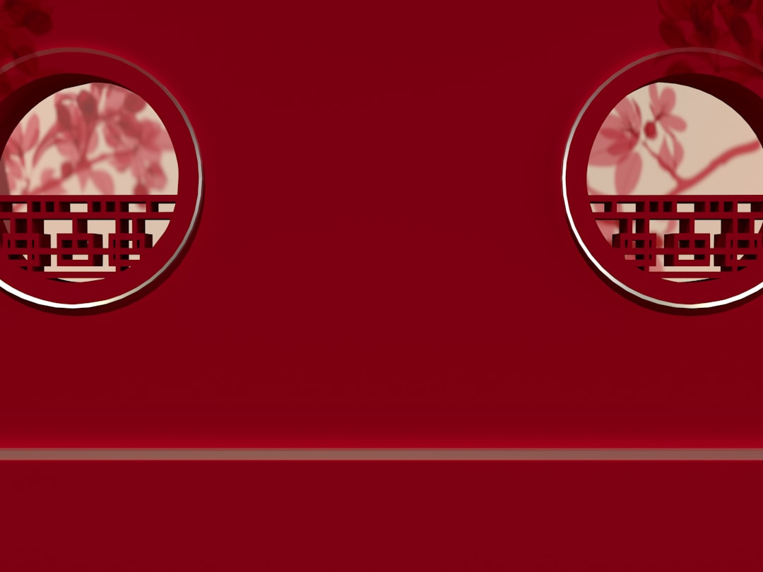 a close up of a red wall with two circular windows