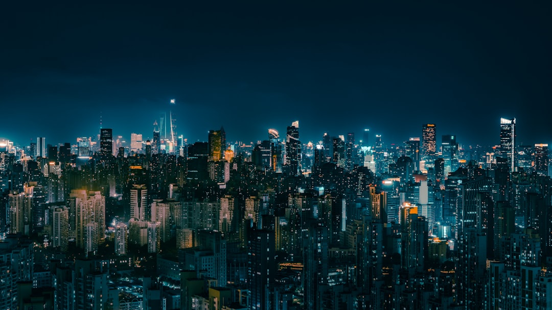 Vibrant cityscape illuminated at night under a dark sky.