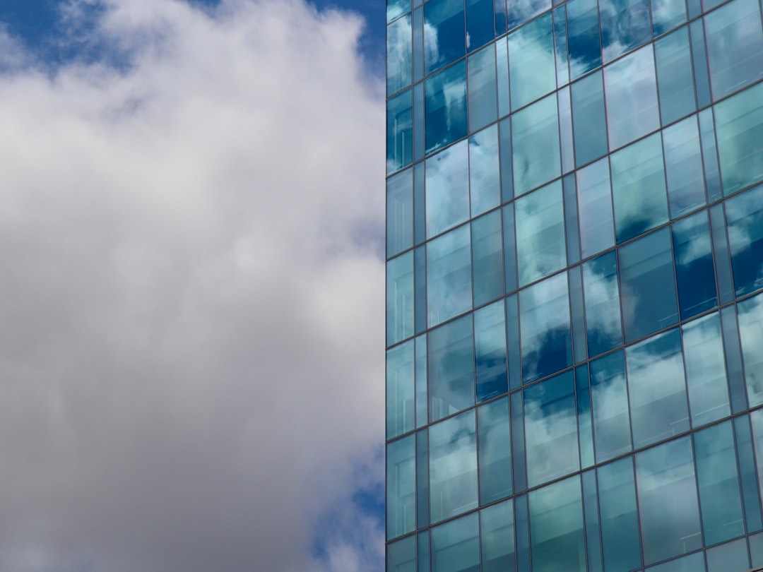 blue and white concrete building under white clouds
