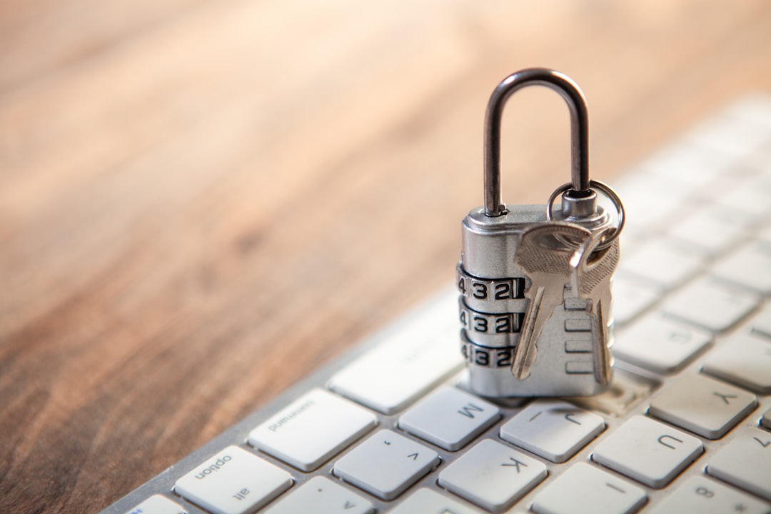 Padlock and keys resting on a computer keyboard.