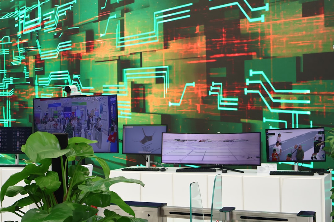 Digital screens display data on a circuit board background