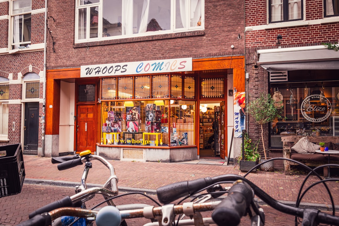 A storefront for a comic book store with bicycles outside.