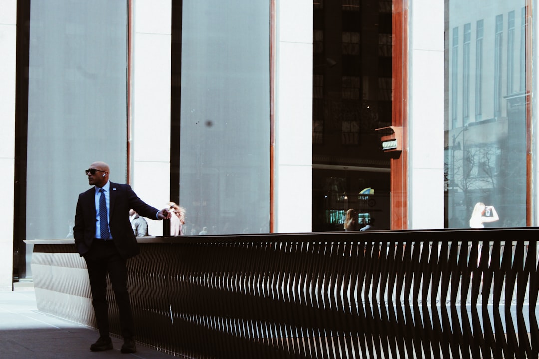 Man in suit standing by modern building