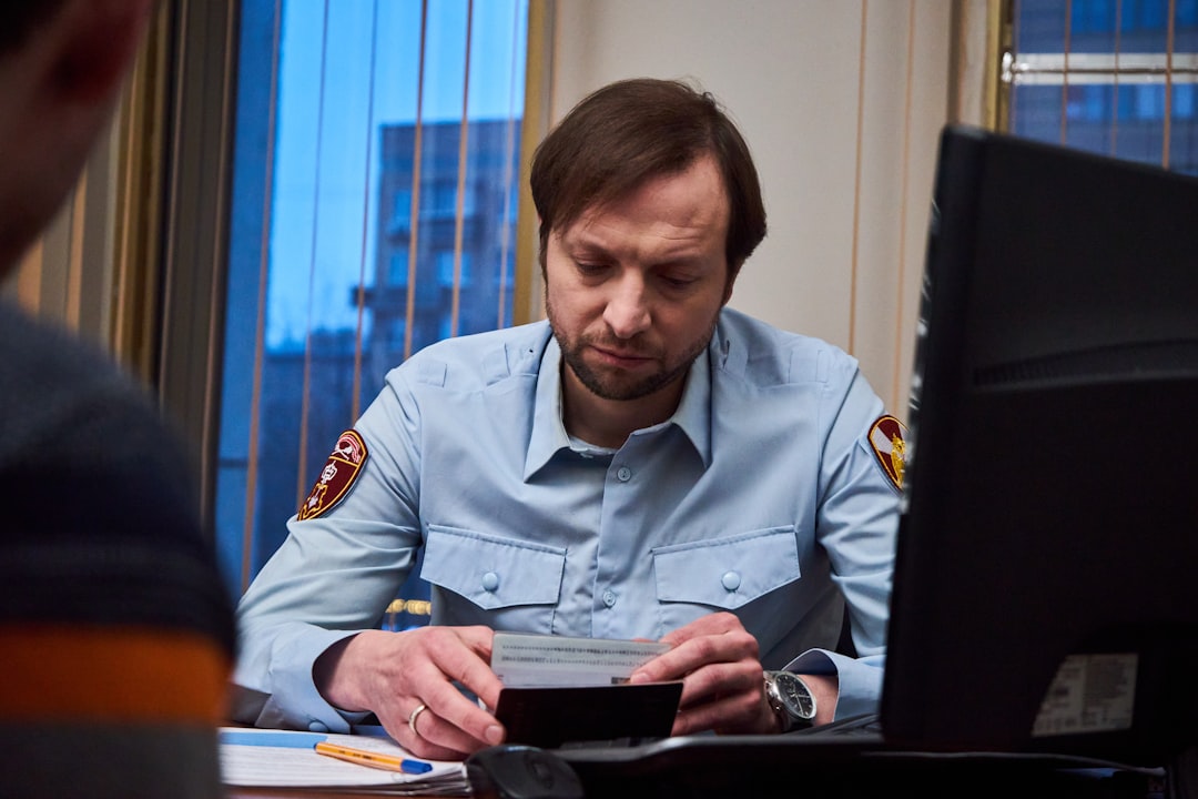 woman in blue button up shirt sitting at the table