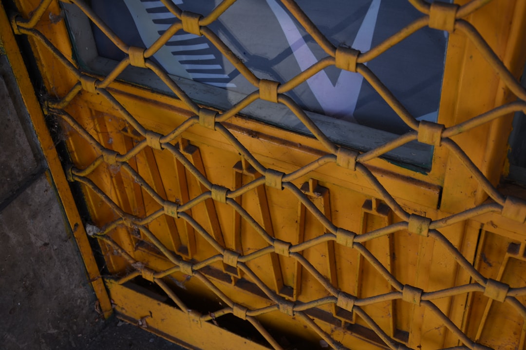 Yellow metal grate over a window